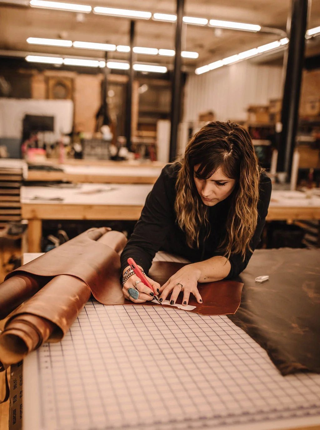 Jill working with leather in the Chariton workshop