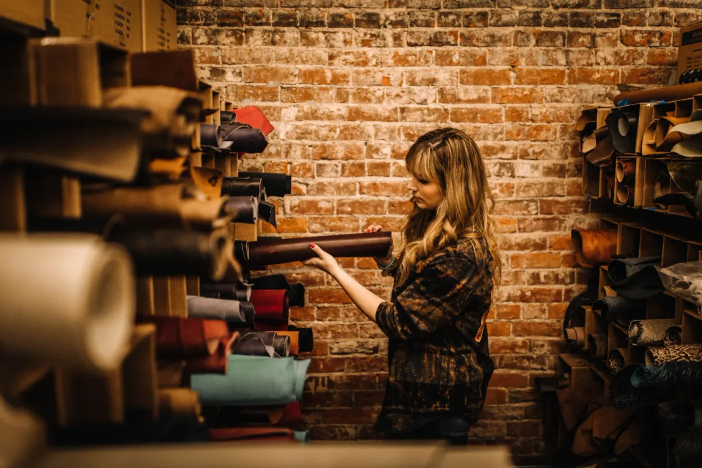A Jill’s Homestead artisan selecting leather in the Iowa workshop