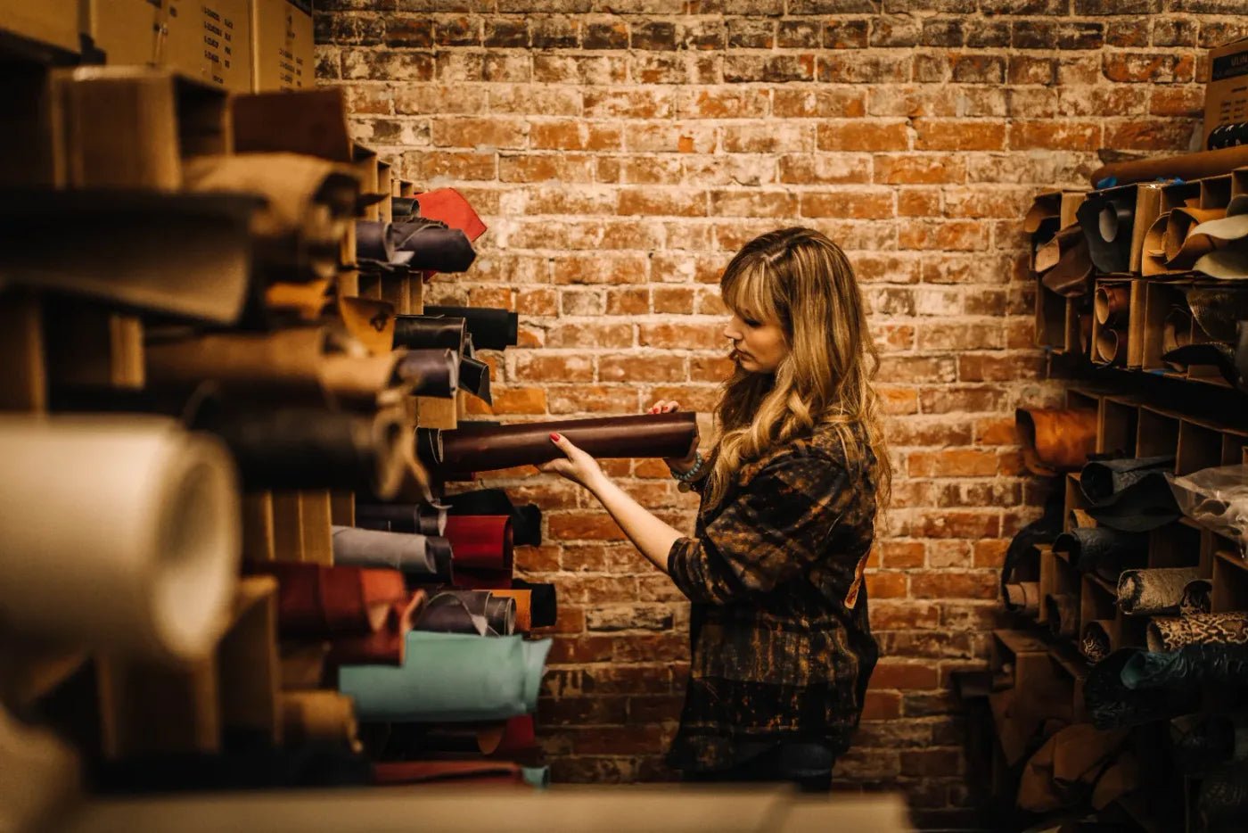 A Jill’s Homestead artisan selecting leather in the Iowa workshop